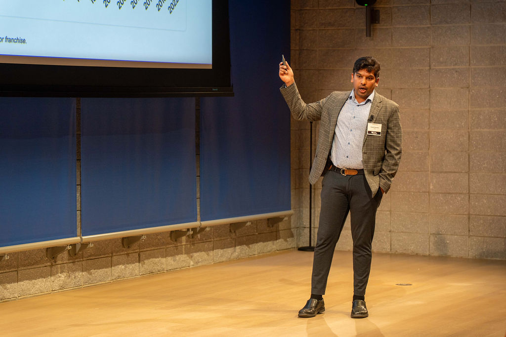 Founder presenting on stage at Fintech Demo Day 2025