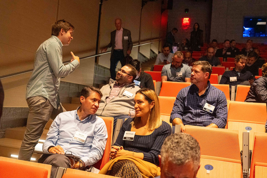 Founder speaking with attendees seated in the auditorium