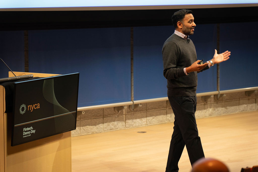 Founder presenting next to NYCA Fintech Demo Day podium