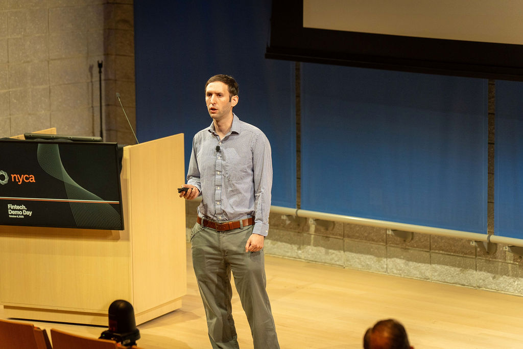 Founder presenting next to the NYCA podium