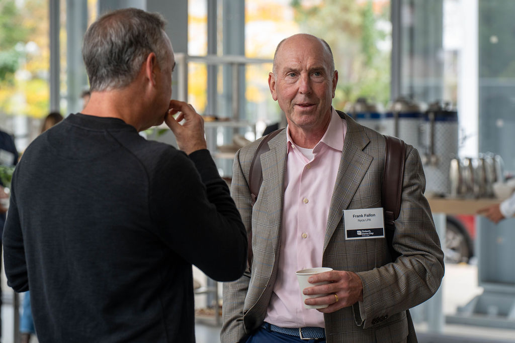 Frank Fallon and an attendee chatting during the morning reception